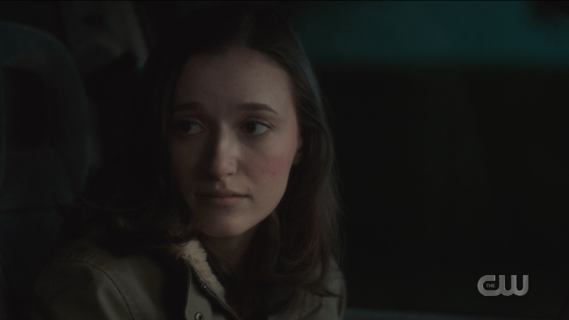 Young Alex looks at her sister with a serious expression.