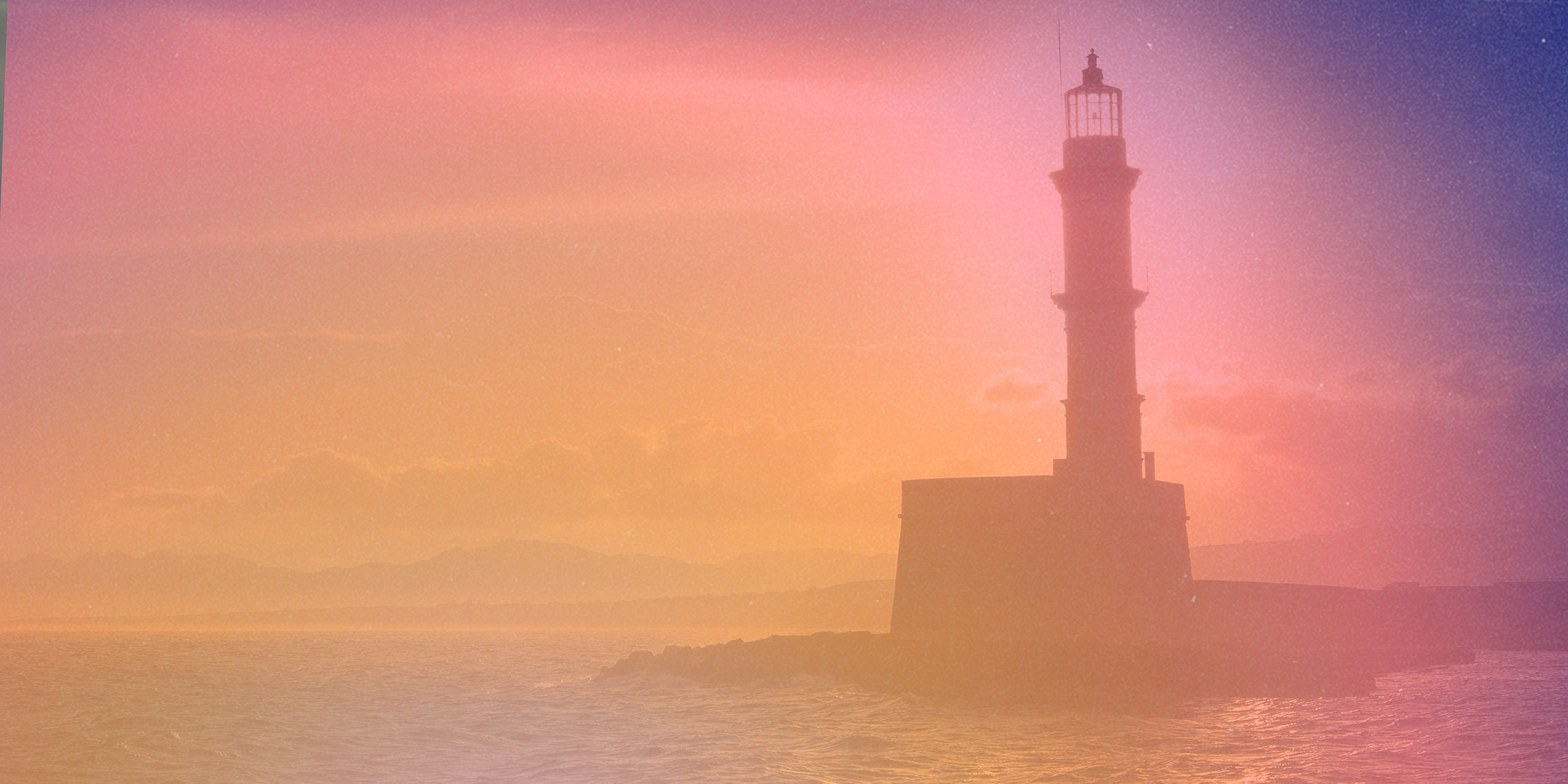 The image of a lighthouse with a color gradient of orange to purple on it.